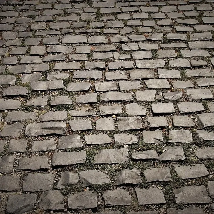 Uneven cobblestones with wide gaps between the stones.
