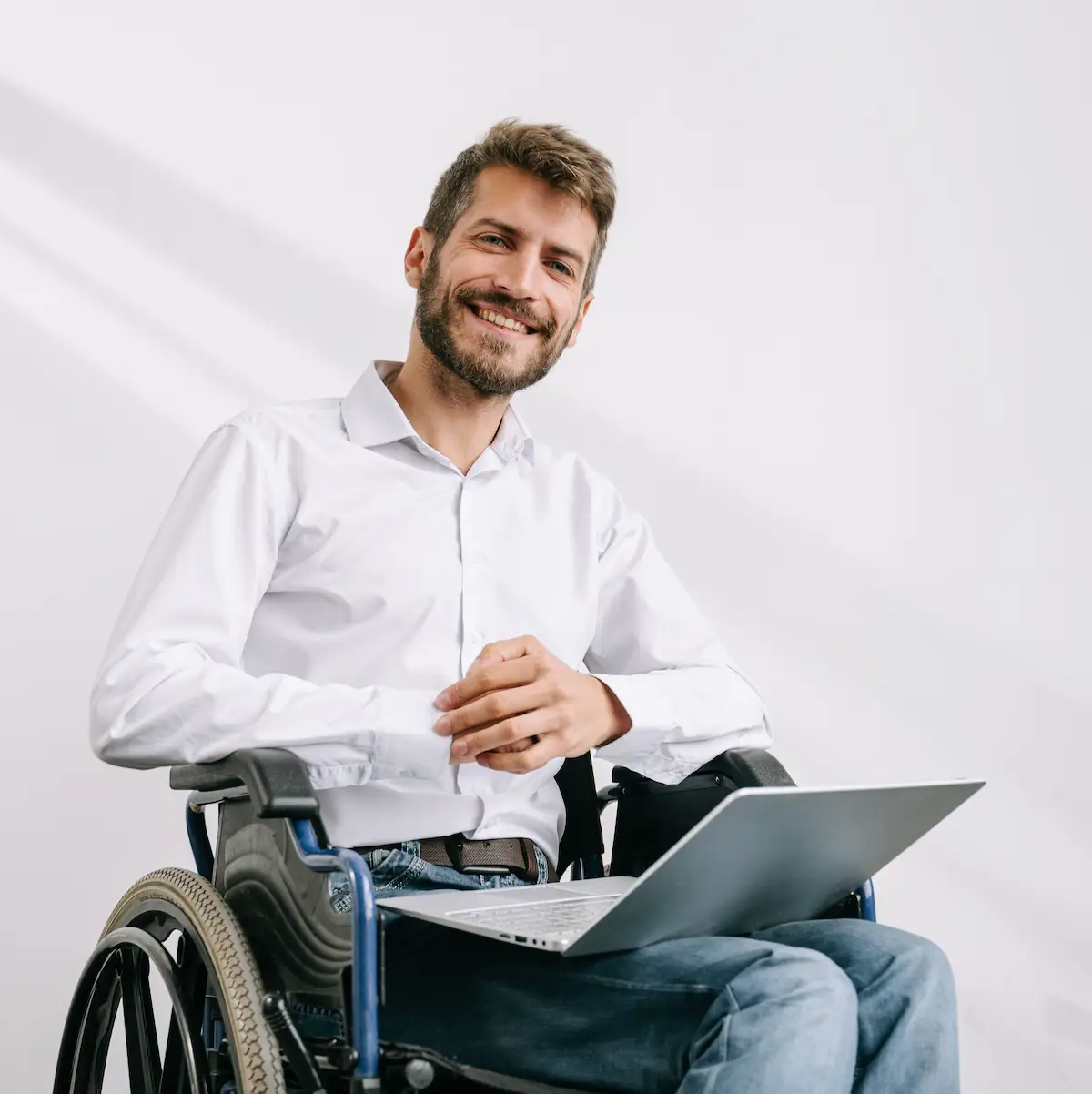 Man in a wheelchair with a laptop on his lap